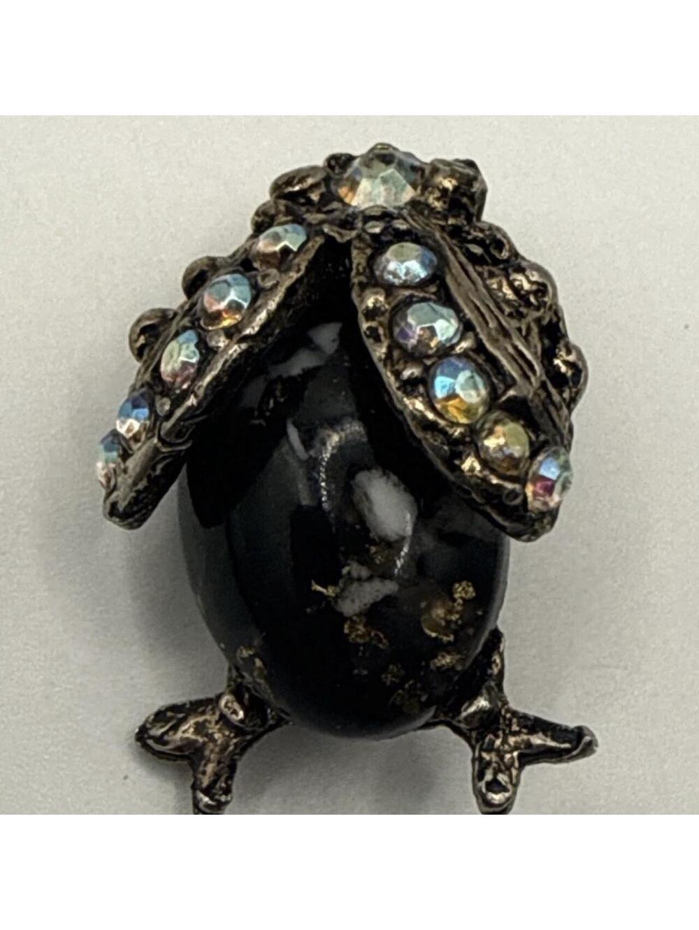 Black & silver brooch with rhinestones and gold accents
